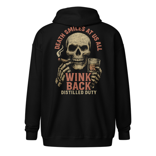 Distilled Duty “Wink Back” zip-up hoodie featuring a skull smoking a cigar and holding a bourbon glass with the quote “Death Smiles at Us All.”